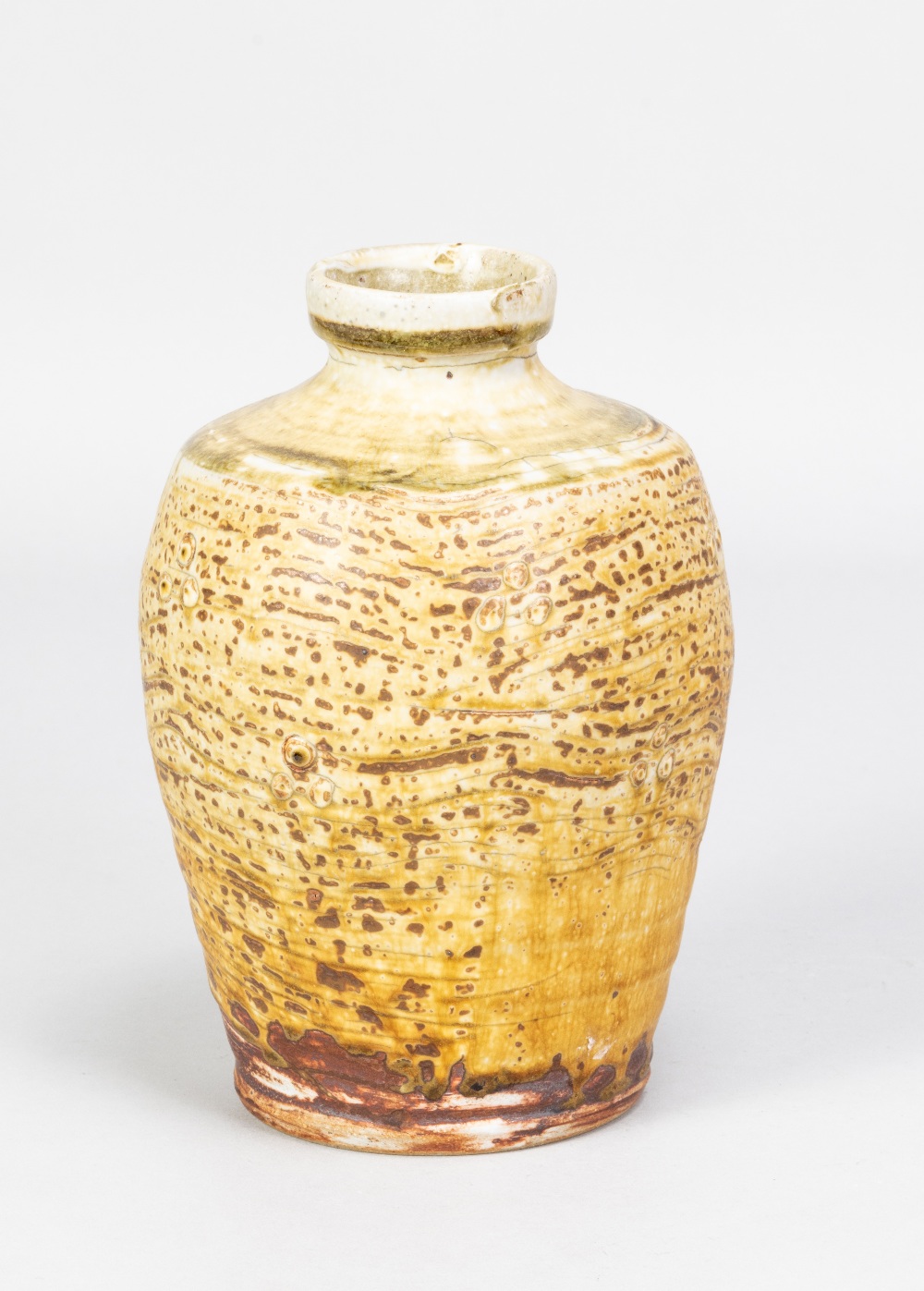 MIKE DODD (born 1943); a stoneware bottle covered in mottled oatmeal glaze with green top, impressed