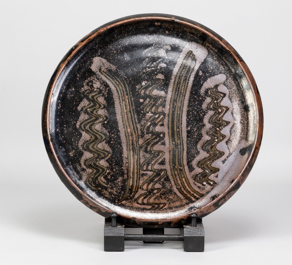 BAWA USHAFA for Abuja Pottery; a large stoneware platter with wax resist decoration on tenmoku