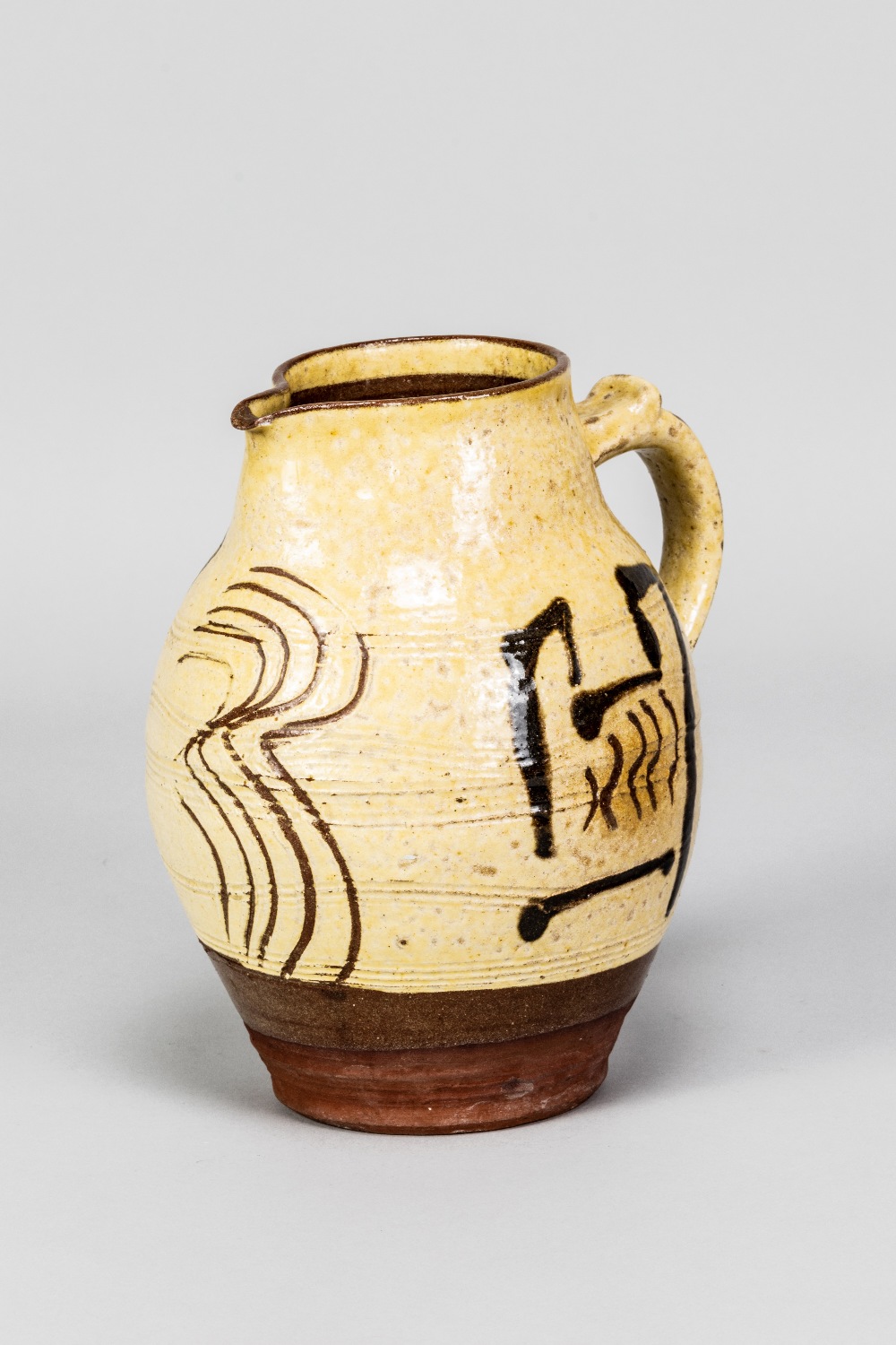 SAM HAILE (1909-1948); a slipware jug partially covered in yellow glaze with incised and painted