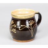 PAUL BARRON (1917-1983); a slipware mug with floral decoration, impressed B mark, made circa 1954,