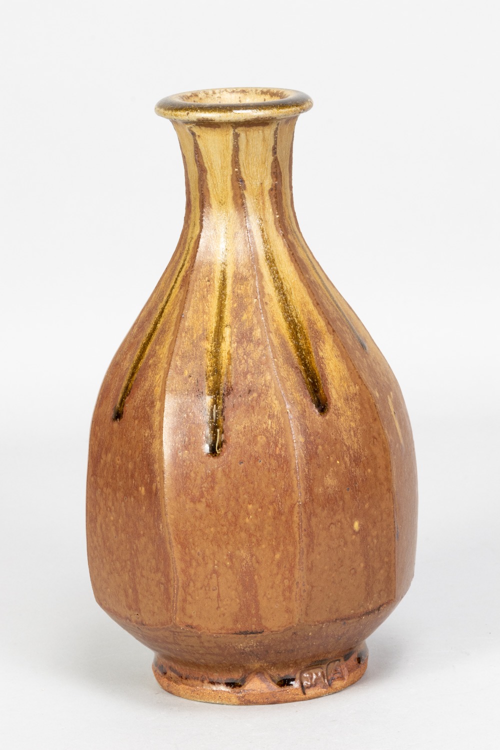 JIM MALONE (born 1946); a cut sided stoneware bottle covered in brown and running green ash glaze,