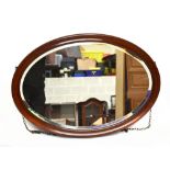 An Edwardian mahogany oval wall mirror with bevelled plate, width 84cm, height 59cm.Additional