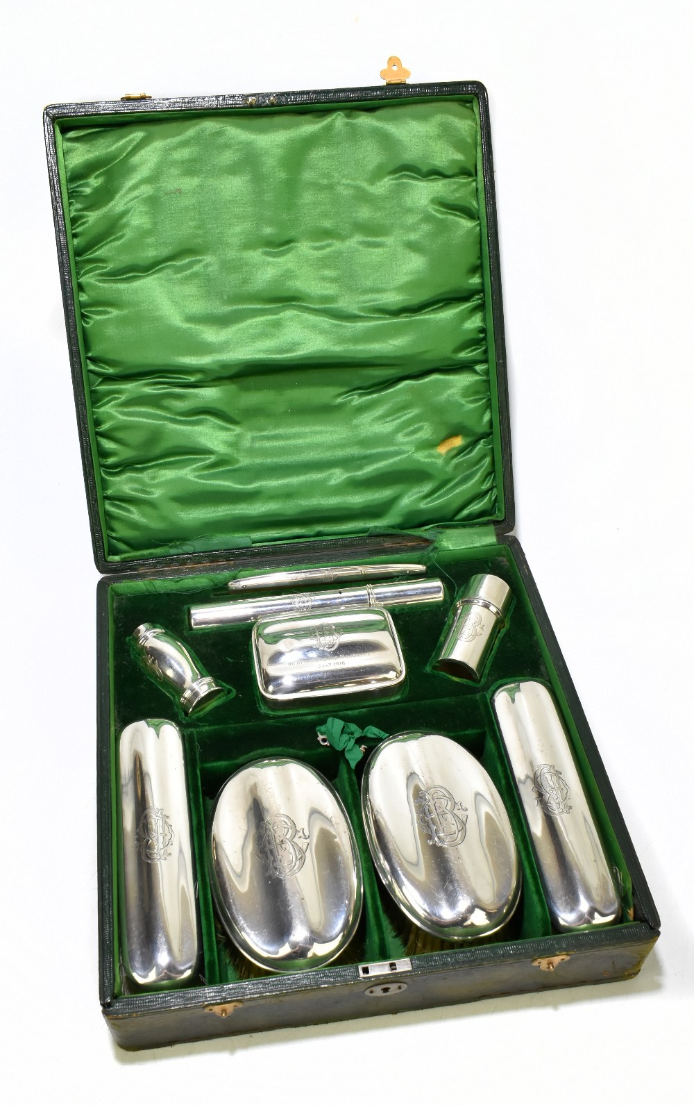 ROBERT CHANDLER; a cased George V hallmarked silver nine piece gentleman's vanity set, comprising