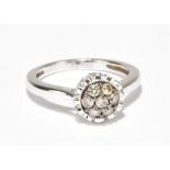 LE VIAN; a white and chocolate diamond set white metal ring set with seven chocolate coloured