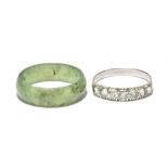 A white metal seven stone dress ring and a jade coloured ring (2).Additional InformationPlease