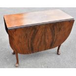 An early 20th century Art Deco style figured walnut veneered dropleaf dining table raised on