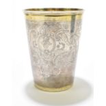 An early 18th century Russian parcel-gilt silver beaker of large size, the exterior with a repeating