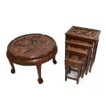 A Chinese carved hardwood circular coffee table the top decorated with a harbour scene with boats, a