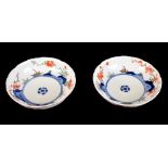A pair of Japanese kakiemon porcelain bowls with crimped rims, the interior with underglaze blue and