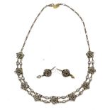 KENNY MA; a base metal necklace set with nine floral mounts, length 41cm, with a matching pair of