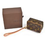 LOUIS VUITTON; a Monogram coated canvas small bag with cow hide leather trim and lined with red