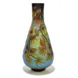 AFTER EMILE GALLE; a moulded glass vase decorated with pine cones and leaves against a blue