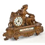 A late 19th century gilt spelter eight day mantel clock modelled with a seated female figure, the