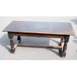 An 18th century style stained oak refectory table, with rectangular top on turned and block legs