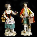 MEISSEN; a pair of 19th century hard paste porcelain figures representing a gentleman holding a