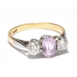 An 18ct yellow gold platinum mounted diamond and morganite three stone ring, the central oval pale