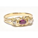 A diamond and ruby set yellow metal three stone ring, approx. size N, weight approx. 2.5g (A/F).