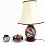 MOORCROFT; three pieces comprising a baluster form table lamp decorated in the 'Anemone' patter,