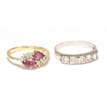 An 18ct gold diamond and red spinel ring, set with two pear shaped red spinels and six small