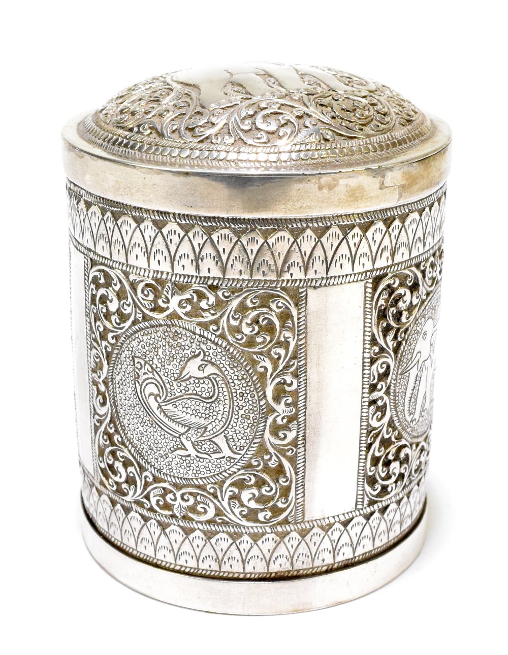 An Eastern white metal cylindrical tea canister and cover, the lift-off lid decorated with an