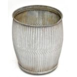 A galvanised wash tub with ribbed detailing and pouring spout, height 54cm, diameter 49cm.Additional