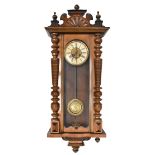 An early 20th century walnut and beech cased Vienna style wall clock, the circular dial with Roman