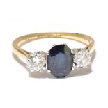 An 18ct yellow gold platinum mounted sapphire and diamond three stone ring, the central oval