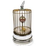 A mid 20th century Art Deco style tabletop desktop mystery clock modelled as a bird within cage,