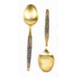 A pair of Russian 875 grade silver gilt and niello spoons, with floral decoration, stamped 875 and