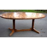***WITHDRAWN*** A 1970s rosewood extending dining table, with oval top on two circular column