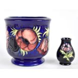 MOORCROFT; a planter decorated in the 'Anemone' pattern on a blue ground, height 17cm, together with