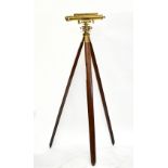 WEST OF LONDON; a brass lacquered theodolite raised on wooden tripod stand, overall height 166cm.