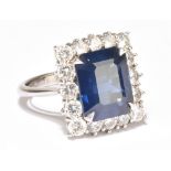 GRAFF; a fine 18ct white gold sapphire and diamond ring, the emerald cut sapphire weighing approx.