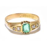 An Edwardian 18ct yellow gold emerald and diamond ring, the central rounded rectangular cut