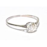 A white metal and diamond solitaire ring, the round cut stone approx 0.70ct in an eight claw