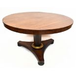 A William IV rosewood circular breakfast table, with a tapering octagonal column and gilt lower