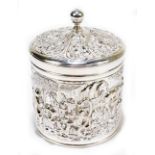 A Dutch silver cylindrical tea canister with knop finial above lid and body decorated with figures