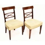 A set of four Regency inlaid mahogany dining chairs, raised on spade feet, upholstered in a cream