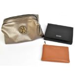 HUGO BOSS; a brand new, unused soft brown leather coin purse with gold tone zip and logo to front,