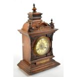 A late 19th century German walnut eight day mantel clock, with Roman numeral chapter ring and