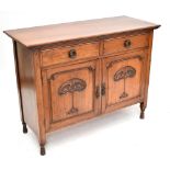 An Art Nouveau walnut sideboard with two drawers and two cupboard doors on turned legs, height 92cm,
