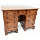 A 19th century mahogany lady’s writing pedestal desk, with one central drawer and two cupboard doors