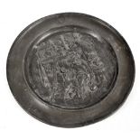 A pewter plate decorated with a tavern scene and with oval punched mark to the rim, width 35cm.