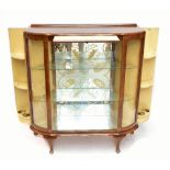 A 1950s walnut display cabinet with pullout slide which actions two opening side panels, with