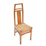 An Arts & Crafts oak hall chair with pierced splat back and rush seat.Additional InformationHeight