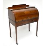 An Edwardian mahogany and line inlaid cylinder top desk raised on square sectioned tapering legs