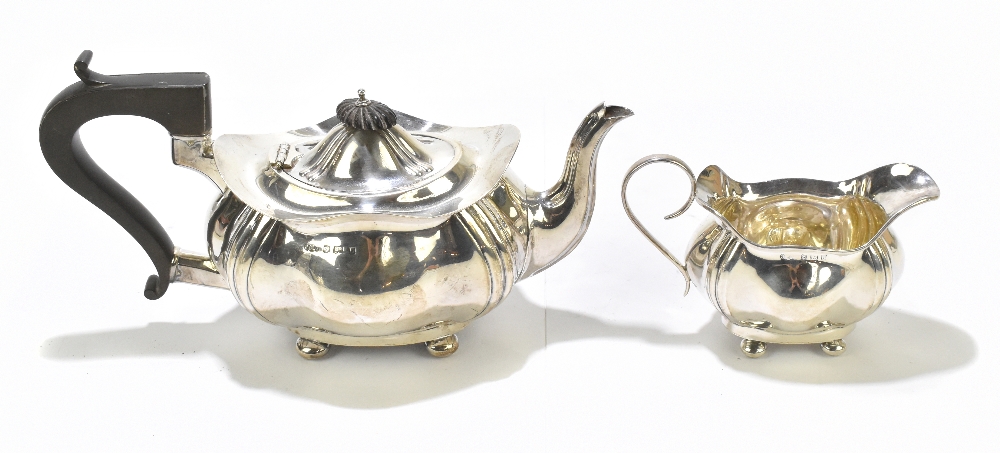 JOSEPH GLOSTER LTD; a George V hallmarked silver teapot and milk jug, each of shaped oval form