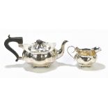 JOSEPH GLOSTER LTD; a George V hallmarked silver teapot and milk jug, each of shaped oval form
