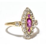 A Victorian diamond and ruby set yellow metal navette shaped ring, with three rubies surrounded by