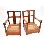 A near pair of contemporary Arts & Crafts style walnut low chairs with drop-in caned seats and